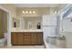 Bathroom with double vanity, walk in shower, and neutral finishes at 8608 Willow Cabin St, Las Vegas, NV 89131