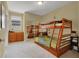 Bedroom with carpeted floors, bunkbeds, and a closet with mirrored sliding doors at 8608 Willow Cabin St, Las Vegas, NV 89131