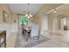 Formal dining area with a chandelier, wainscoting, and large window overlooking the backyard at 8608 Willow Cabin St, Las Vegas, NV 89131