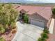 Charming single-story home featuring a three-car garage, tile roof, desert landscaping and a welcoming front entrance at 8608 Willow Cabin St, Las Vegas, NV 89131