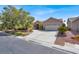 Charming single-story home with a red tile roof, desert landscaping, and an attached two-car garage at 8608 Willow Cabin St, Las Vegas, NV 89131