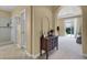 Hallway with dark wood cabinet and glass shower with natural light shining through at 8608 Willow Cabin St, Las Vegas, NV 89131