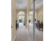 Spacious hallway with neutral carpet and an arched entrance to a bright, open living area at 8608 Willow Cabin St, Las Vegas, NV 89131