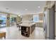 Open kitchen with large island, stainless steel appliances, and access to the backyard at 8608 Willow Cabin St, Las Vegas, NV 89131