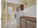 Functional laundry room with modern washer and dryer, storage cabinets, and natural light at 8608 Willow Cabin St, Las Vegas, NV 89131