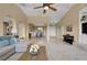 Open-concept living space featuring large windows, stylish furnishings, and tile flooring at 8608 Willow Cabin St, Las Vegas, NV 89131