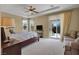 Bright main bedroom featuring a ceiling fan, backyard access, and comfortable seating area at 8608 Willow Cabin St, Las Vegas, NV 89131