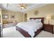 Spacious main bedroom features a seating area, ceiling fan, and neutral decor at 8608 Willow Cabin St, Las Vegas, NV 89131