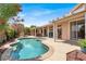 Inviting backyard pool area with covered patio, BBQ, and lush landscaping for outdoor relaxation and entertaining at 8608 Willow Cabin St, Las Vegas, NV 89131