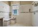 Modern shower with glass door, decorative tile, window, and a built-in bench at 8608 Willow Cabin St, Las Vegas, NV 89131