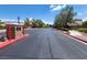 View down a street in the neighborhood with landscaped sidewalks, street lamps and green trees at 8608 Willow Cabin St, Las Vegas, NV 89131