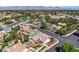 An aerial view showcasing the lush neighborhood, mountain views, and various homes in the community at 8761 Anchor Point Ave, Las Vegas, NV 89117