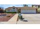 Charming single-story home featuring a well-manicured lawn and a two-car garage at 8761 Anchor Point Ave, Las Vegas, NV 89117