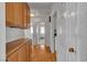 Hallway with hardwood floors features built in cabinets and access to laundry room and bedroom at 8761 Anchor Point Ave, Las Vegas, NV 89117