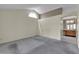 Open living room featuring vaulted ceilings and a large window, adjacent to the bathroom at 8761 Anchor Point Ave, Las Vegas, NV 89117