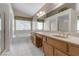 Inviting bathroom featuring a bathtub, separate shower, vanity, and dual sinks for convenience at 8761 Anchor Point Ave, Las Vegas, NV 89117