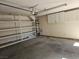 Spacious garage with shelving for organization and a water heater at 8813 Pavia Dr, Las Vegas, NV 89117