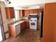 A kitchen with stainless steel appliances and wooden cabinets, next to a window at 8813 Pavia Dr, Las Vegas, NV 89117