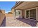 Covered back patio with brick flooring and a well-maintained brick wall, a perfect spot for outdoor relaxation at 8873 Howell St, Las Vegas, NV 89166
