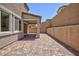 Covered back patio with brick flooring and a well-maintained brick wall, offering a private outdoor retreat at 8873 Howell St, Las Vegas, NV 89166