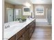 Bathroom featuring double sinks, vanity, mirror, and a separate tub and shower at 8873 Howell St, Las Vegas, NV 89166