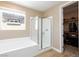 Bathroom showcases a glass-enclosed shower, tub, and access to a walk-in closet at 8873 Howell St, Las Vegas, NV 89166