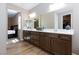 Bathroom features a double vanity, mirror, and access to bedroom and walk-in closet at 8873 Howell St, Las Vegas, NV 89166