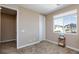 Bright bedroom featuring neutral tones, a window for natural light, and access to a doorway at 8873 Howell St, Las Vegas, NV 89166