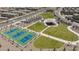 Community park featuring tennis courts, shade structure, parking, and green spaces in a residential area at 8873 Howell St, Las Vegas, NV 89166