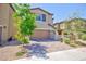Inviting two-story home featuring a neutral color scheme, well-maintained landscaping and brick paver driveway at 8873 Howell St, Las Vegas, NV 89166