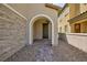 Inviting front porch with stone accents and tiled walkway leading to a dark wood front door at 8873 Howell St, Las Vegas, NV 89166
