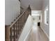 Entry hallway featuring wood-look floors, staircase with wood railing, and an abundance of natural light at 8873 Howell St, Las Vegas, NV 89166