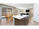 Open-concept kitchen with a center island, dining area, and seamless flow into the living room at 8873 Howell St, Las Vegas, NV 89166