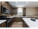 Stylish kitchen featuring stainless steel appliances, a tile backsplash, and a center island at 8873 Howell St, Las Vegas, NV 89166