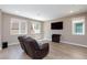 Spacious living room featuring hardwood floors, a media center, and comfortable seating at 8873 Howell St, Las Vegas, NV 89166