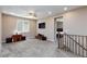 Spacious loft area with a ceiling fan, large window, and stairs to the lower level at 8873 Howell St, Las Vegas, NV 89166