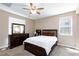 Serene main bedroom with natural light, a bed, a dresser, and ceiling fan at 8873 Howell St, Las Vegas, NV 89166