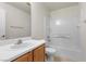 Well-lit bathroom featuring a shower-tub combination, single sink vanity, and white tile walls at 9174 Mcginnis Ave, Las Vegas, NV 89148