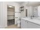 Bright bathroom featuring a walk-in closet, stylish marble countertop, and tile flooring at 9174 Mcginnis Ave, Las Vegas, NV 89148