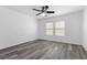 Bedroom featuring wood-look flooring, ceiling fan and dual windows with blinds at 9174 Mcginnis Ave, Las Vegas, NV 89148