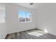 Bright bedroom with hardwood floors and a large window providing natural light at 9174 Mcginnis Ave, Las Vegas, NV 89148