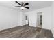 Bedroom features a ceiling fan, wood-look flooring, a walk-in closet and bathroom access at 9174 Mcginnis Ave, Las Vegas, NV 89148