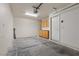 Spacious garage interior with built-in storage cabinets, an automatic door opener, and clean concrete flooring at 9174 Mcginnis Ave, Las Vegas, NV 89148