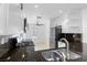 Well-lit kitchen featuring modern appliances, granite countertops, and white cabinetry at 9174 Mcginnis Ave, Las Vegas, NV 89148