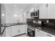 Modern kitchen featuring white cabinetry, granite countertops, and stainless steel appliances at 9174 Mcginnis Ave, Las Vegas, NV 89148
