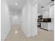 Bright kitchen area featuring white cabinetry and views to the living room at 9174 Mcginnis Ave, Las Vegas, NV 89148