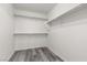 Spacious walk-in closet featuring ample shelving and clothing rods, along with attractive plank flooring at 9174 Mcginnis Ave, Las Vegas, NV 89148