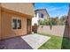 Backyard featuring brick patio, low-maintenance artificial grass, and shrubbery at 992 Wagner Valley St, Henderson, NV 89052