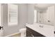 Clean bathroom with a modern vanity, toilet, shower, and window at 992 Wagner Valley St, Henderson, NV 89052