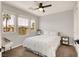 Bright bedroom with natural light, ceiling fan, and view of palm trees through the windows at 992 Wagner Valley St, Henderson, NV 89052